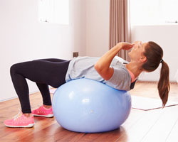 Woman stretching back on exercise ball